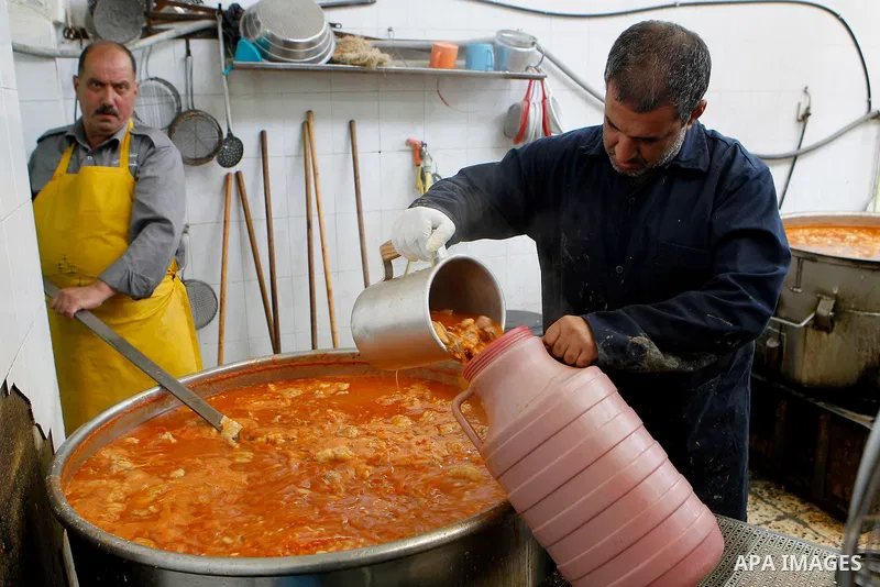 Palestinians prepare food to be distributed for free during the holy fasting month of Ramadan in the West Bank city of Hebron, 13 June 2016. the "Ibrahimi Takiya" was founded in 960 AD as an institute provides food for o...
