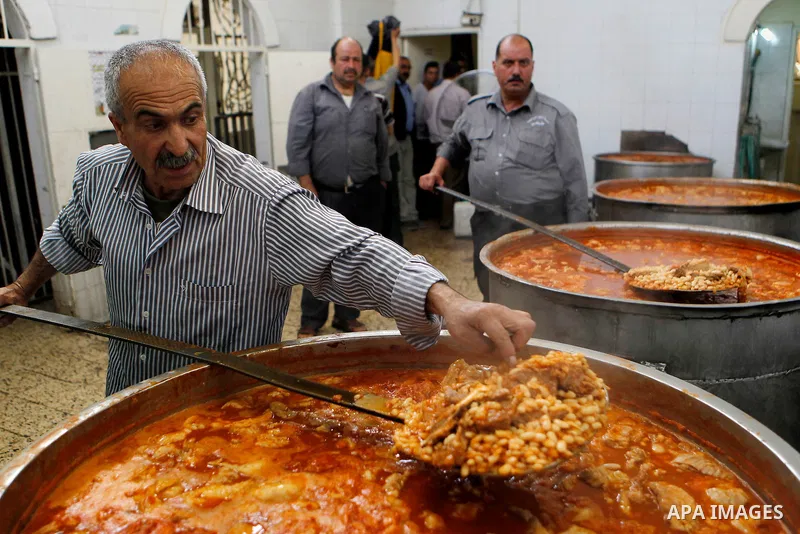 Palestinians prepare food to be distributed for free during the holy fasting month of Ramadan in the West Bank city of Hebron, 13 June 2016. the "Ibrahimi Takiya" was founded in 960 AD as an institute provides food for o...