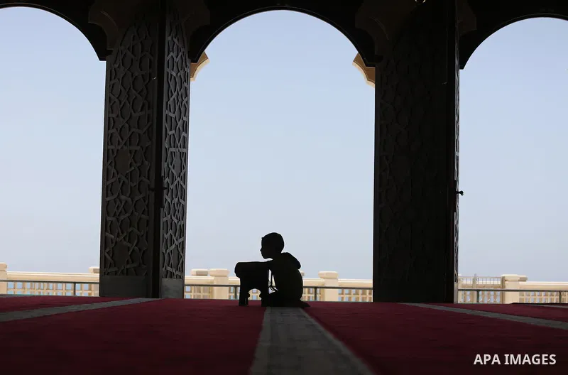 A Palestinian boy sits reading the Koran, Islam's holy book, at the al-Khaldi mosque during the Muslim fasting month of Ramadan, in Gaza City on June 13, 2016. Photo by Mohammed Asad
