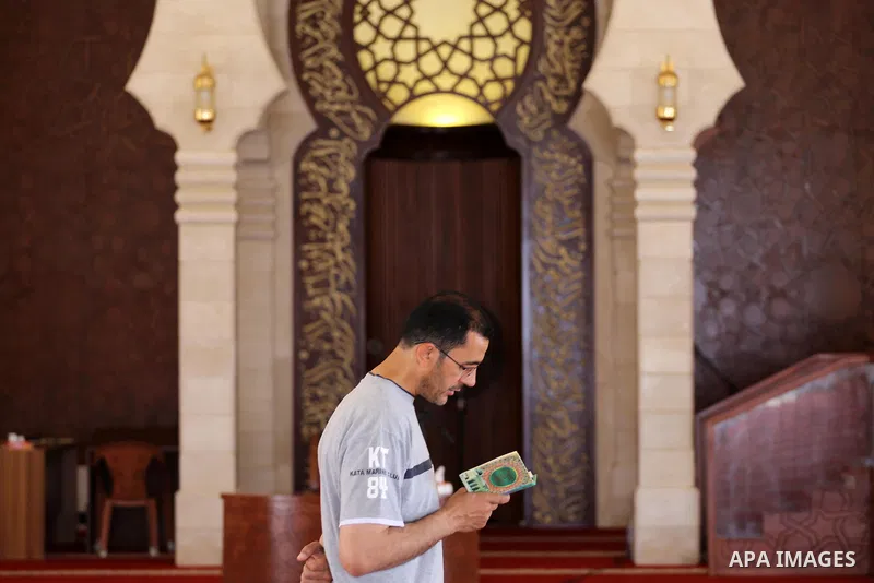 A Palestinian man sits reading the Koran, Islam's holy book, at the al-Khaldi mosque during the Muslim fasting month of Ramadan, in Gaza City on June 13, 2016. Photo by Mohammed Asad