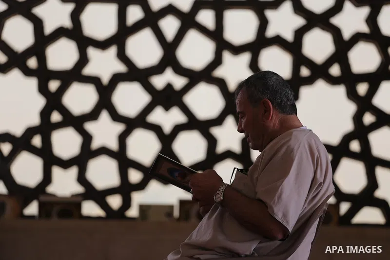 A Palestinian man sits reading the Koran, Islam's holy book, at the al-Khaldi mosque during the Muslim fasting month of Ramadan, in Gaza City on June 13, 2016. Photo by Mohammed Asad