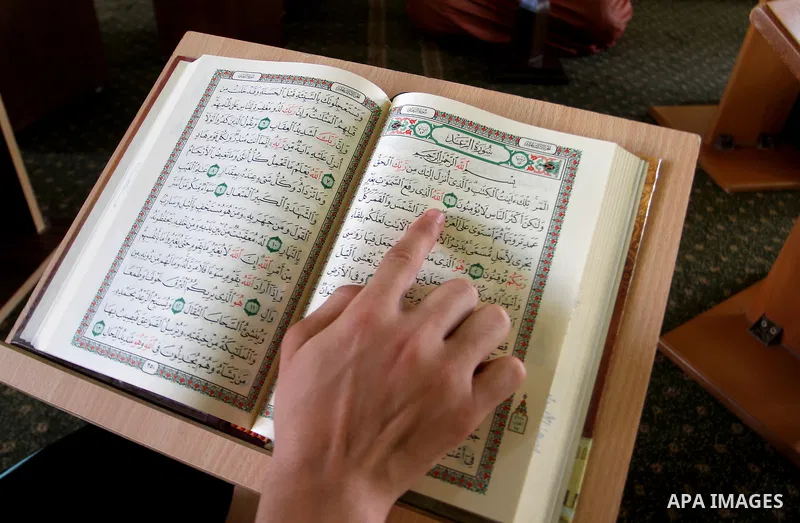 A Palestinian man sits reading the Koran, Islam's holy book, at the mosque during the Muslim fasting month of Ramadan, in Rafah in the southern Gaza strip on June 13, 2016. Photo by Abed Rahim Khatib