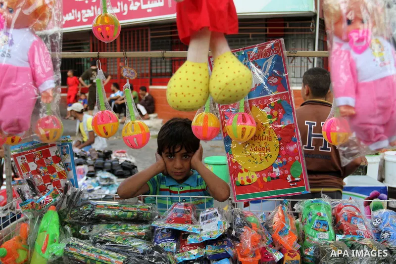 A Palestinian vendor displays games at a market during the Muslim fasting month of Ramadan, in Rafah in the southern Gaza strip on June 13, 2016. Photo by Abed Rahim Khatib