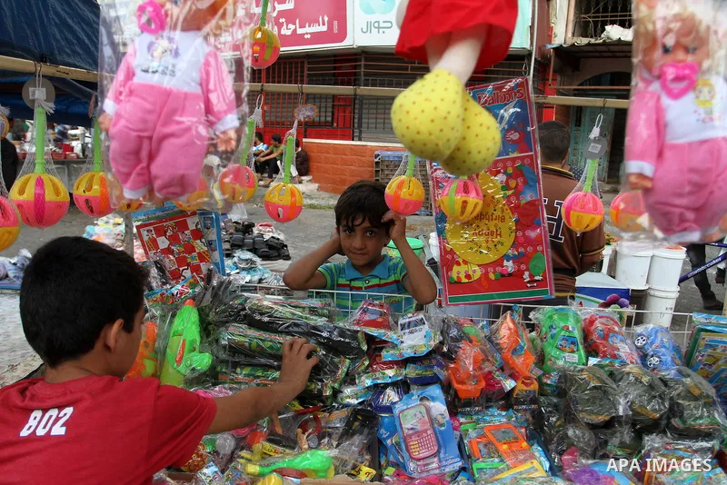 A Palestinian vendor displays games at a market during the Muslim fasting month of Ramadan, in Rafah in the southern Gaza strip on June 13, 2016. Photo by Abed Rahim Khatib