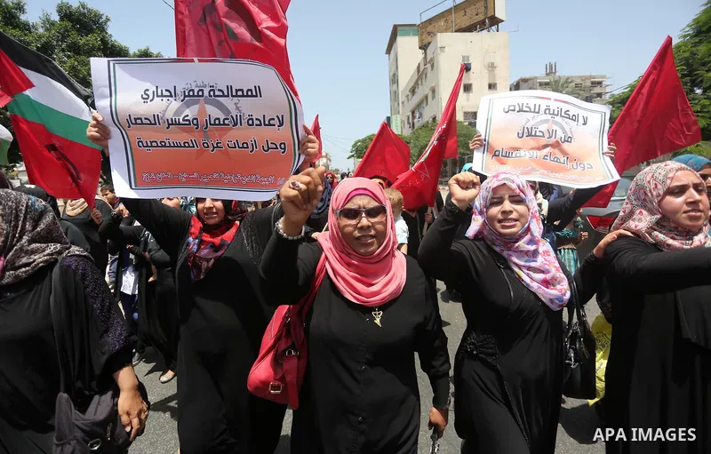 Palestinian supporters of the Democratic Front for the Liberation of Palestine (DFLP) shout slogans and hold banners during a demonstration to calling for an end in the political division and the national reconciliation,...