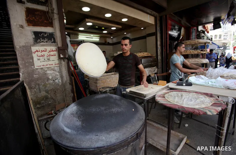 A Palestinian man prepares a traditional bread, during the Muslim fasting month of Ramadan, in the West Bank city of Nablus, on June 14, 2016. Photo by Nedal Eshtayah