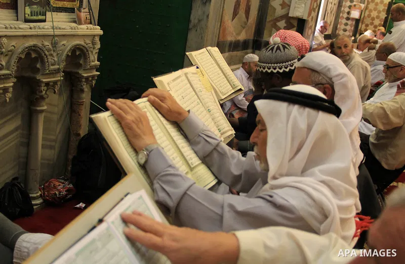 Palestinian men read the Koran, Islam's holy book, at al-Aqsa mosque during the holy month of Ramadan, in Jerusalem's old city on June 14, 2016. Ramadan is sacred to Muslims because it is during that month that tradition...
