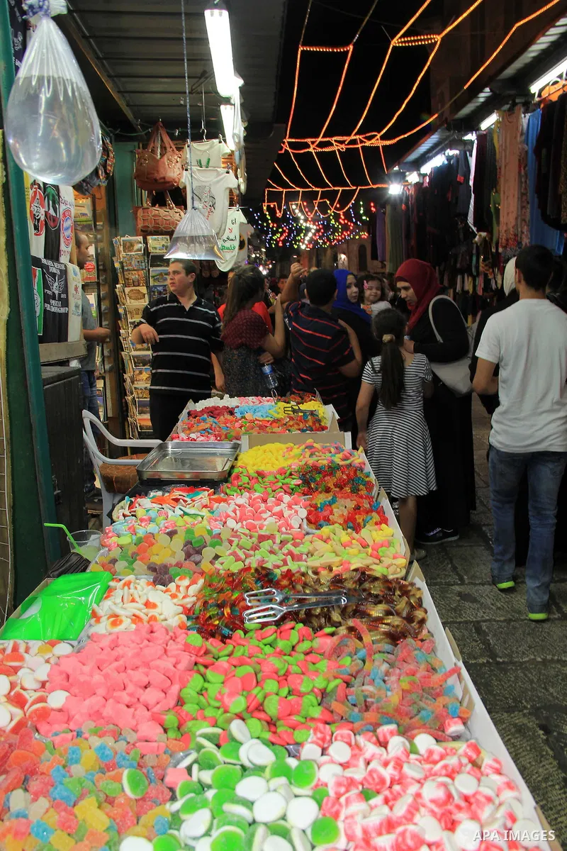 Palestinians shop at a market following "Taraweeh", nightly prayer of the month of Ramadan, at al-Aqsa mosque, in Jerusalem's old city on June 14, 2016. Ramadan is sacred to Muslims because it is during that month that t...