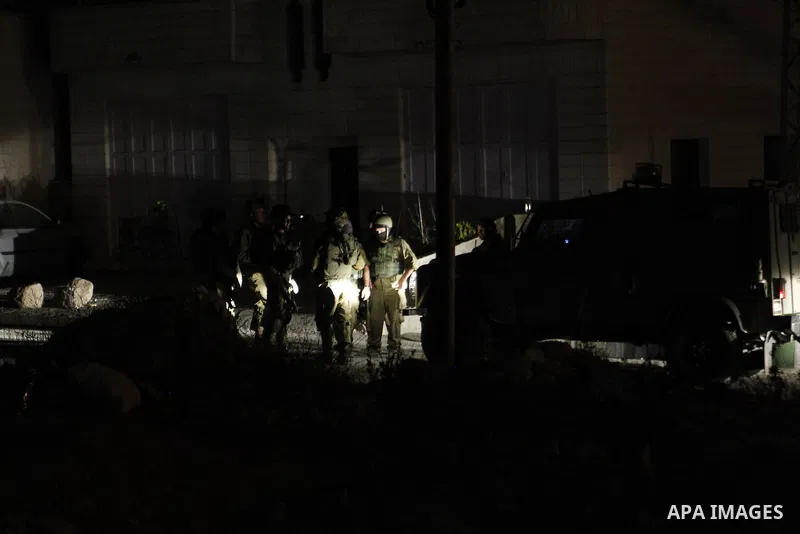 Israeli army soldiers stand guard during a searching and arresting in the West Bank village of Yatta June 15 2016. the Israeli army carry on a night after night military campaign in Yatta after 2 Palestinians attacked an...