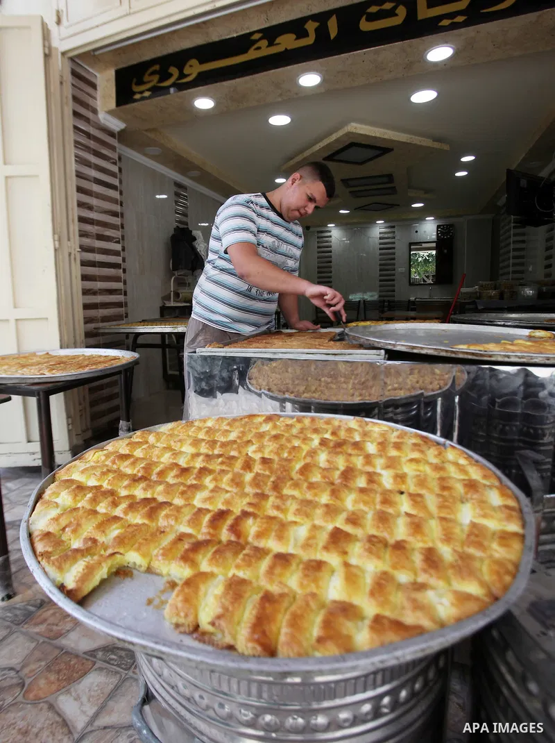 A Palestinian vendor sells sweets at his shop at a market during the holy month of Ramadan in the West Bank city of Nablus, on June 15, 2016. Ramadan is sacred to Muslims because it is during that month that tradition sa...