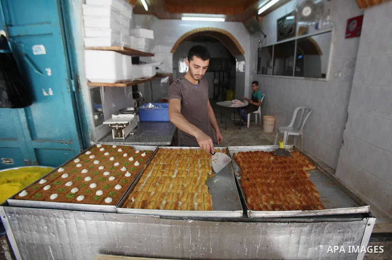 A Palestinian vendor sells sweets at his shop at a market during the holy month of Ramadan in the West Bank city of Nablus, on June 15, 2016. Ramadan is sacred to Muslims because it is during that month that tradition sa...