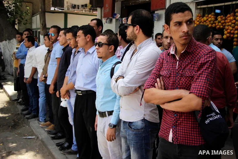 Egyptians Who obtained master's degree hold placards and shout slogans during a protest to demand jobs in Cairo, Egypt, on June 15, 2016. Photo by Amr Sayed