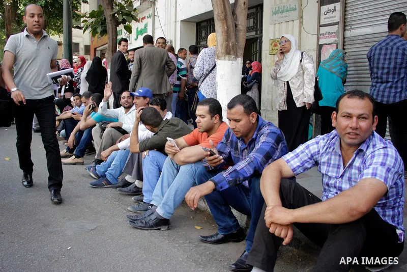 Egyptians Who obtained master's degree hold placards and shout slogans during a protest to demand jobs in Cairo, Egypt, on June 15, 2016. Photo by Amr Sayed