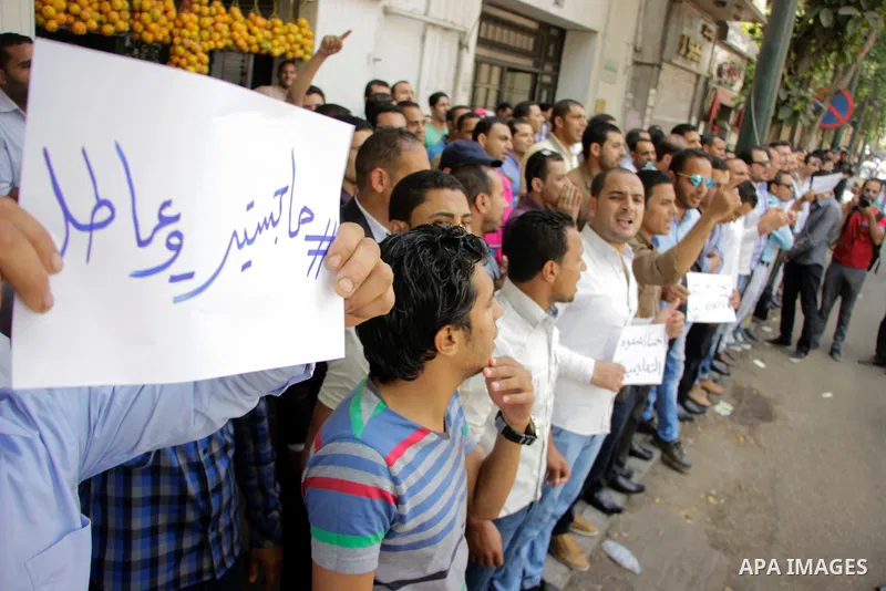 Egyptians Who obtained master's degree hold placards and shout slogans during a protest to demand jobs in Cairo, Egypt, on June 15, 2016. Photo by Amr Sayed