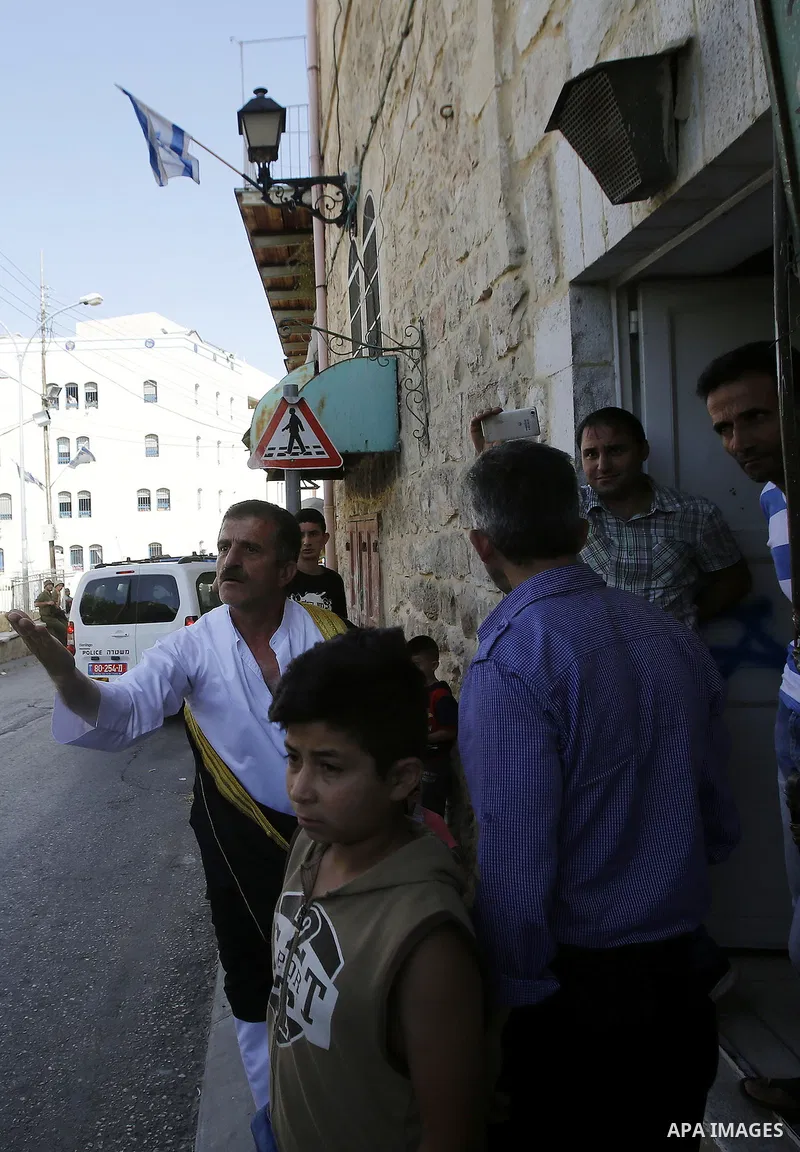 A Palestinian man shouts at Israeli troops after his son was pushed following a protest against the closure of a route used by Palestinians to pass to a school and houses in Shuhada street, in the West Bank city of Hebro...