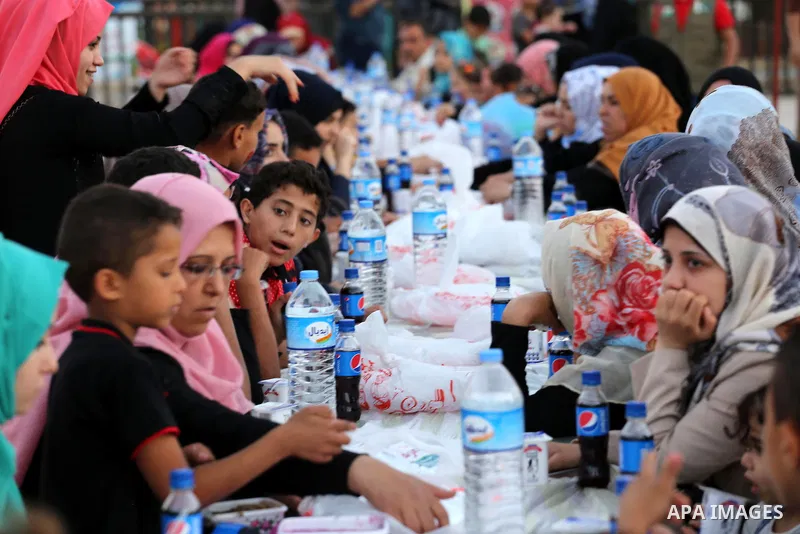 Palestinian Muslims eat their Iftar meal as they break their fast during the holy fasting month of Ramadan, in Gaza city on June 15, 2016. Ramadan is sacred to Muslims because it is during that month that tradition says...