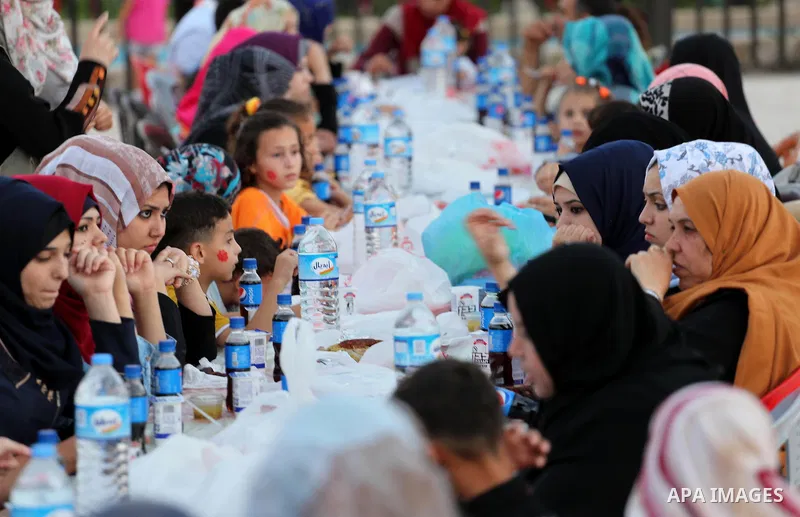 Palestinian Muslims eat their Iftar meal as they break their fast during the holy fasting month of Ramadan, in Gaza city on June 15, 2016. Ramadan is sacred to Muslims because it is during that month that tradition says...