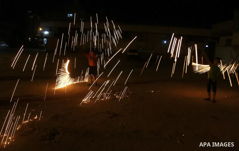 A Palestinian boy plays with fire crackers at street celebrating on the holy month of Ramadan in Rafah in the southern Gaza strip, on June 15, 2016. Ramadan is sacred to Muslims because it is during that month that tradi...
