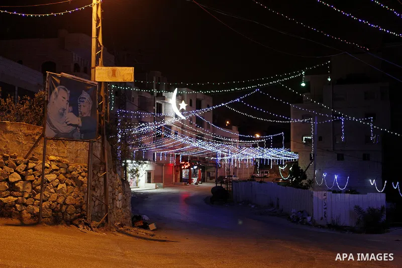 Lighting decorations are seen at a street during the holy fasting month of Ramadan in the West Bank city of Hebron, June 16, 2016. Muslims around the world celebrate Ramadan, the holy month in the Islamic calendar, in wh...