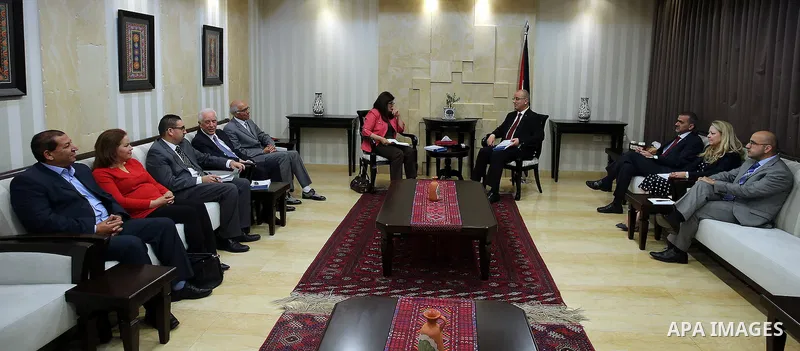 Palestinian Prime Minister Rami Hamdallah receives the Annual report of the Independent Commission for Human Rights for 2015, in the West Bank city of Ramallah on June 16, 2016. Photo by Prime Minister Office