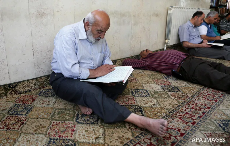 Palestinian Muslim men read the holy Koran, Islam's holy book at a mosque on the holy month of Ramadan in the West bank city of Ramallah, on June 16, 2016. Ramadan is sacred to Muslims because it is during that month tha...