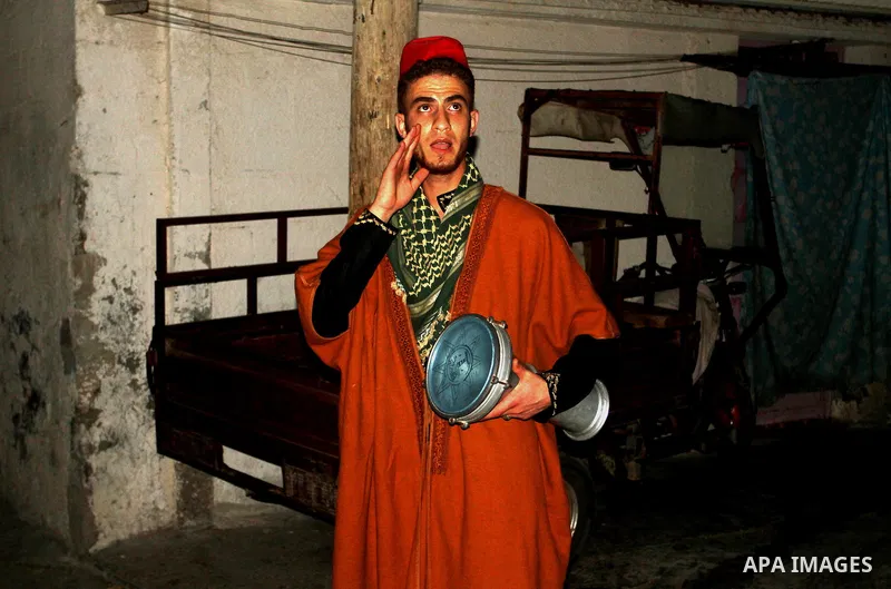 A Palestinian dawn awakener ''al-Musaharati'' walks through streets to wake up Muslims for a meal before sunrise during the fasting month of Ramadan, in Rafah in the southern Gaza strip on June 17, 2016. Al-Musaharati is...
