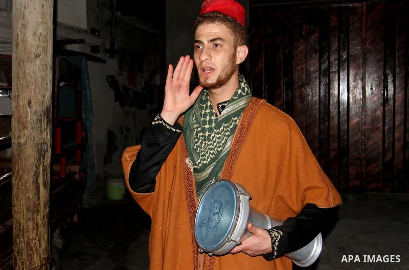 A Palestinian dawn awakener ''al-Musaharati'' walks through streets to wake up Muslims for a meal before sunrise during the fasting month of Ramadan, in Rafah in the southern Gaza strip on June 17, 2016. Al-Musaharati is...