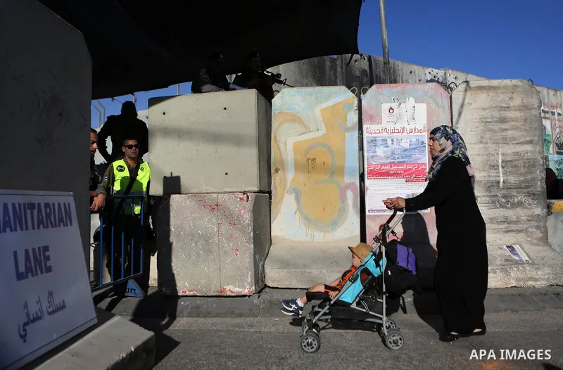 A Palestinian woman cross the Qalandia checkpoint between the West Bank city of Ramallah and Jerusalem on June 17, 2016, as she head to Jerusalem's Al-Aqsa mosque for the second Friday prayer of the holy Muslim fasting m...