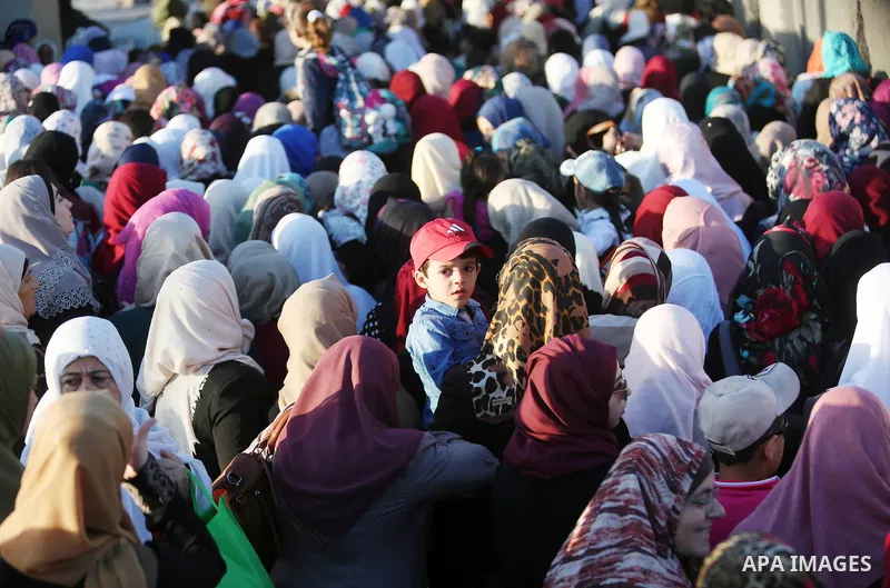 Palestinian women wait to cross the Qalandia checkpoint between the West Bank city of Ramallah and Jerusalem on June 17, 2016, as they head to Jerusalem's Al-Aqsa mosque for the second Friday prayer of the holy Muslim fa...