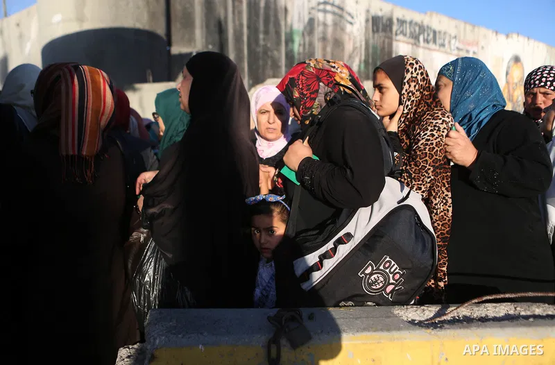 Palestinian women wait to cross the Qalandia checkpoint between the West Bank city of Ramallah and Jerusalem on June 17, 2016, as they head to Jerusalem's Al-Aqsa mosque for the second Friday prayer of the holy Muslim fa...