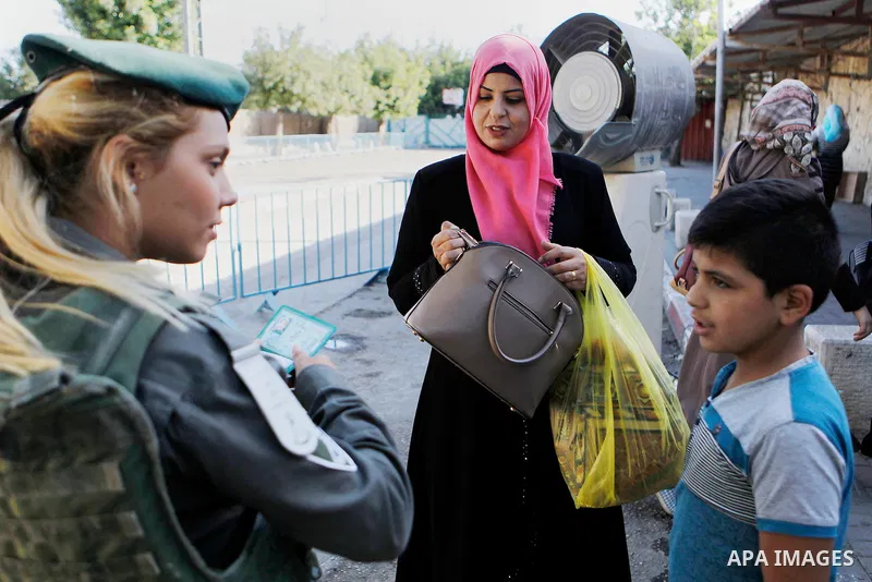 Palestinians are checked at an Israeli checkpoint between the West Bank town of Bethlehem and Jerusalem as Muslim worshippers head to Jerusalem's Al-Aqsa mosque for the second Friday prayer of the holy Muslim fasting mon...