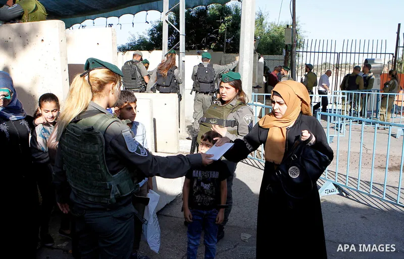 Palestinians are checked at an Israeli checkpoint between the West Bank town of Bethlehem and Jerusalem as Muslim worshippers head to Jerusalem's Al-Aqsa mosque for the second Friday prayer of the holy Muslim fasting mon...