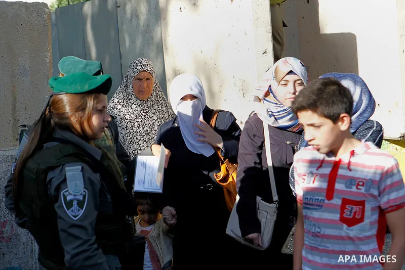 Palestinians are checked at an Israeli checkpoint between the West Bank town of Bethlehem and Jerusalem as Muslim worshippers head to Jerusalem's Al-Aqsa mosque for the second Friday prayer of the holy Muslim fasting mon...