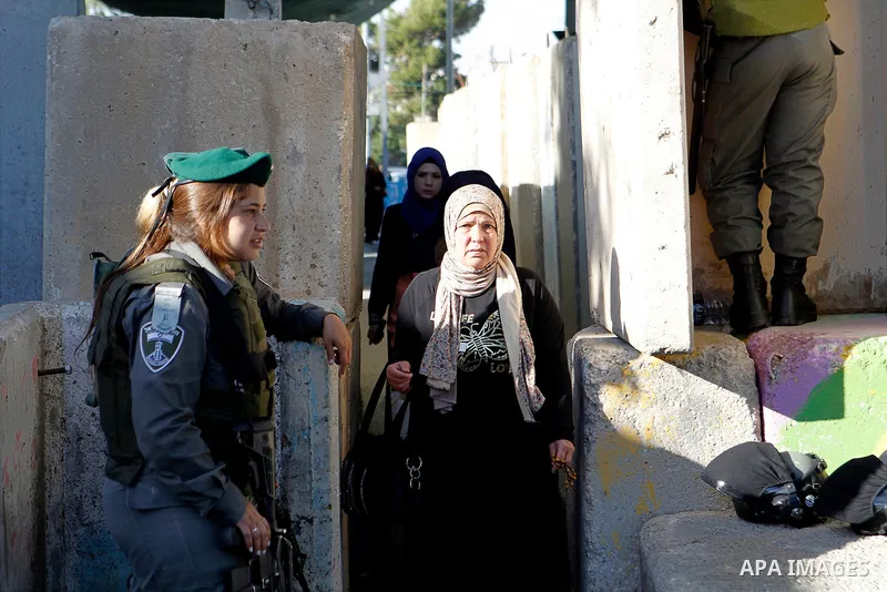 Palestinians are checked at an Israeli checkpoint between the West Bank town of Bethlehem and Jerusalem as Muslim worshippers head to Jerusalem's Al-Aqsa mosque for the second Friday prayer of the holy Muslim fasting mon...