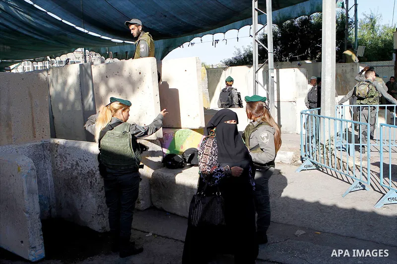 Palestinians are checked at an Israeli checkpoint between the West Bank town of Bethlehem and Jerusalem as Muslim worshippers head to Jerusalem's Al-Aqsa mosque for the second Friday prayer of the holy Muslim fasting mon...