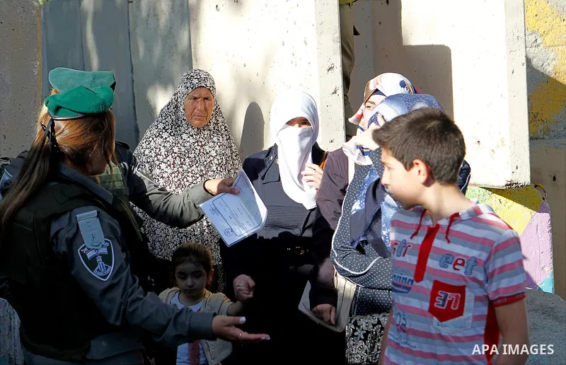 Palestinians are checked at an Israeli checkpoint between the West Bank town of Bethlehem and Jerusalem as Muslim worshippers head to Jerusalem's Al-Aqsa mosque for the second Friday prayer of the holy Muslim fasting mon...