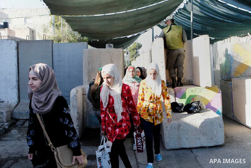 Palestinians are checked at an Israeli checkpoint between the West Bank town of Bethlehem and Jerusalem as Muslim worshippers head to Jerusalem's Al-Aqsa mosque for the second Friday prayer of the holy Muslim fasting mon...