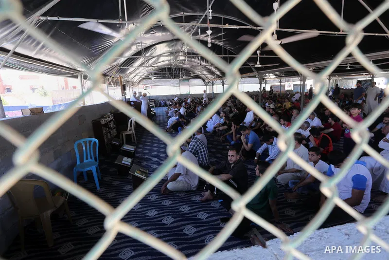 Palestinian Muslim worshippers perform the second Friday prayers of the holy Muslim fasting month of Ramadan at a mosque which was destroyed during the 50-day war between Israel and Hamas militants in the summer of 2014,...