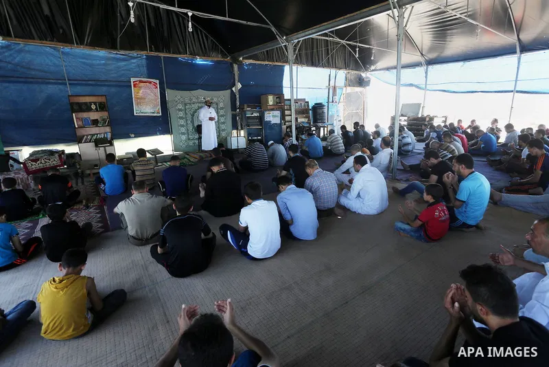 Palestinian Muslim worshippers perform the second Friday prayers of the holy Muslim fasting month of Ramadan at a mosque which was destroyed during the 50-day war between Israel and Hamas militants in the summer of 2014,...