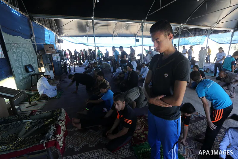 Palestinian Muslim worshippers perform the second Friday prayers of the holy Muslim fasting month of Ramadan at a mosque which was destroyed during the 50-day war between Israel and Hamas militants in the summer of 2014,...