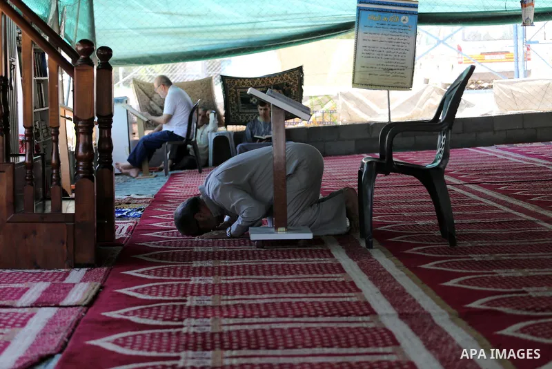 Palestinian Muslim worshippers perform the second Friday prayers of the holy Muslim fasting month of Ramadan at a mosque which was destroyed during the 50-day war between Israel and Hamas militants in the summer of 2014,...