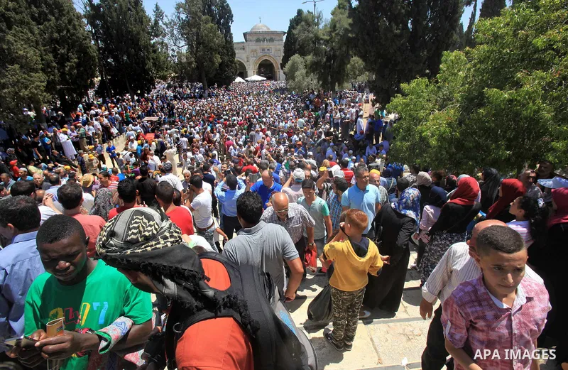Palestinian Muslim worshippers walk outside al-Aqsa mosque following Friday prayer in Jerusalem's old city on June 17, 2016 during the holy fasting month of Ramadan. Around 53,000 Palestinians from the West Bank were all...