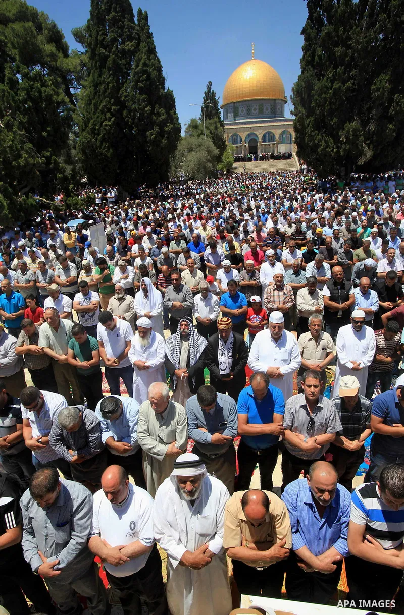 Palestinian Muslim worshippers perform Friday prayer in front of the Dome of the Rock mosque at the al-Aqsa mosque compound in Jerusalem's old city on June 17, 2016 during the holy fasting month of Ramadan. Around 53,000...