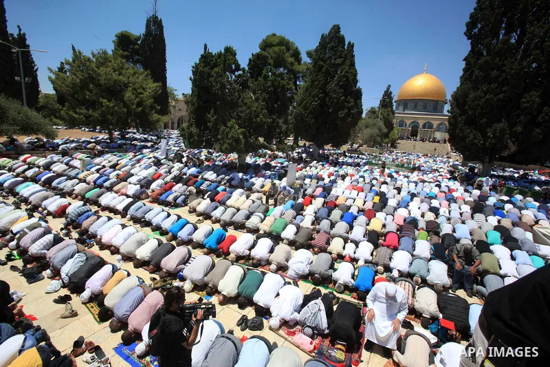 Palestinian Muslim worshippers perform Friday prayer in front of the Dome of the Rock mosque at the al-Aqsa mosque compound in Jerusalem's old city on June 17, 2016 during the holy fasting month of Ramadan. Around 53,000...