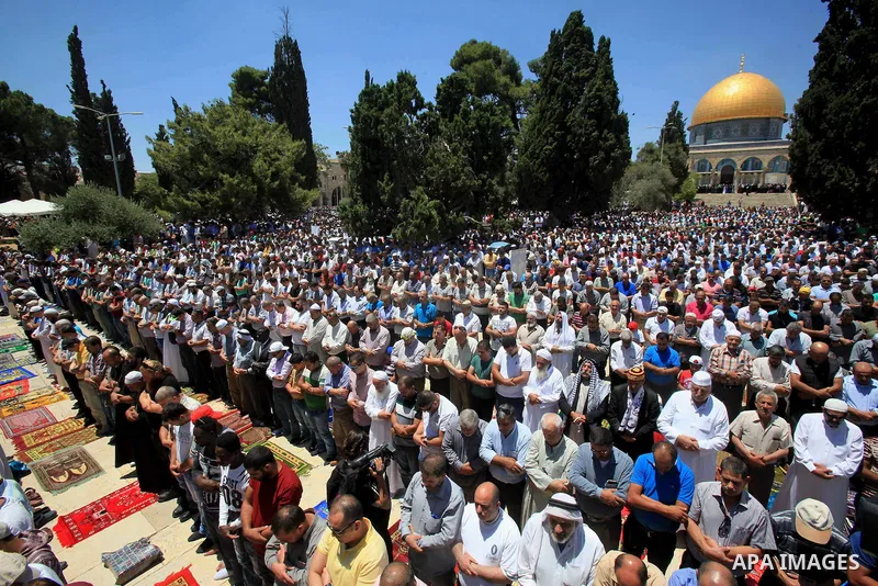Palestinian Muslim worshippers perform Friday prayer in front of the Dome of the Rock mosque at the al-Aqsa mosque compound in Jerusalem's old city on June 17, 2016 during the holy fasting month of Ramadan. Around 53,000...