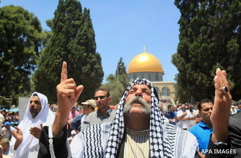 Palestinian Muslim worshippers perform Friday prayer in front of the Dome of the Rock mosque at the al-Aqsa mosque compound in Jerusalem's old city on June 17, 2016 during the holy fasting month of Ramadan. Around 53,000...