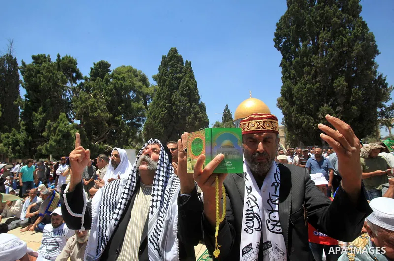 Palestinian Muslim worshippers perform Friday prayer in front of the Dome of the Rock mosque at the al-Aqsa mosque compound in Jerusalem's old city on June 17, 2016 during the holy fasting month of Ramadan. Around 53,000...