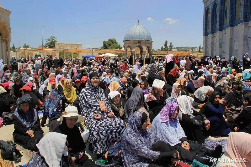 Palestinian women perform Friday prayer in front of the Dome of the Rock mosque at the al-Aqsa mosque compound in Jerusalem's old city on June 17, 2016 during the holy fasting month of Ramadan. Around 53,000 Palestinians...