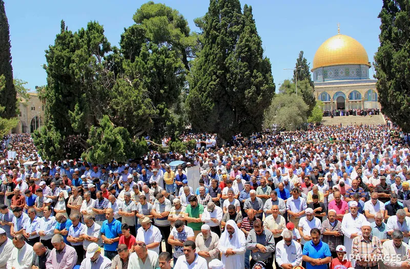 Palestinian Muslim worshippers perform Friday prayer in front of the Dome of the Rock mosque at the al-Aqsa mosque compound in Jerusalem's old city on June 17, 2016 during the holy fasting month of Ramadan. Around 53,000...