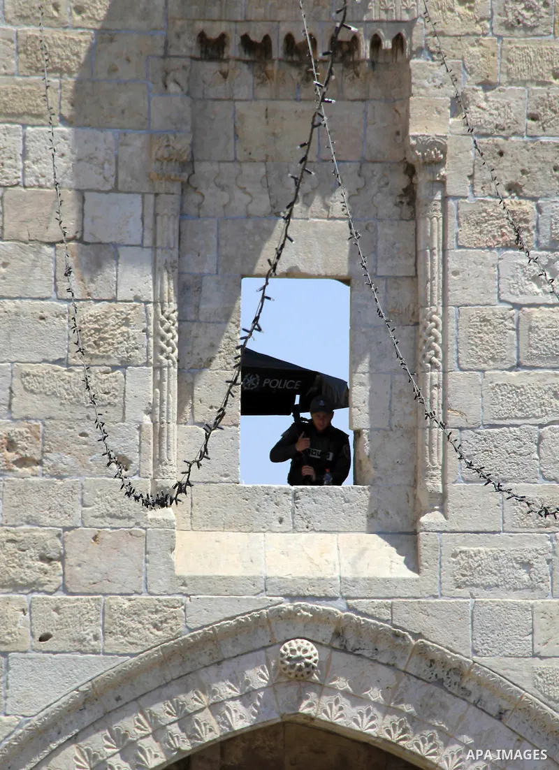 Israeli policeman stands guard following Friday prayer at al-Aqsa mosque on June 17, 2016 during the holy fasting month of Ramadan. Around 53,000 Palestinians from the West Bank were allowed into Jerusalem to pray at Al-...